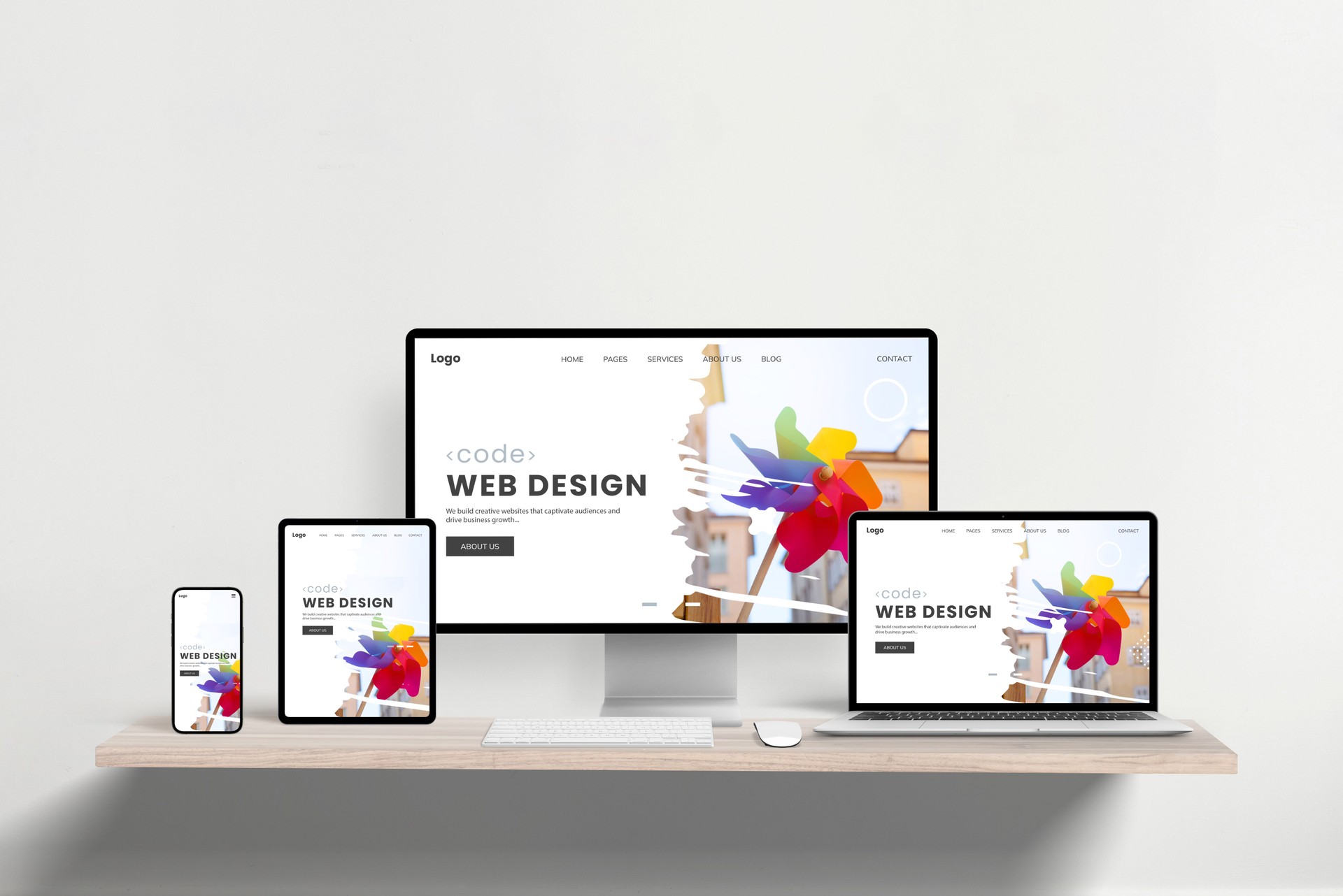 Responsive web design studio page displayed across laptop, phone, tablet, and computer on office desk. Showcasing cross-device functionality and modern presentation for professional web development